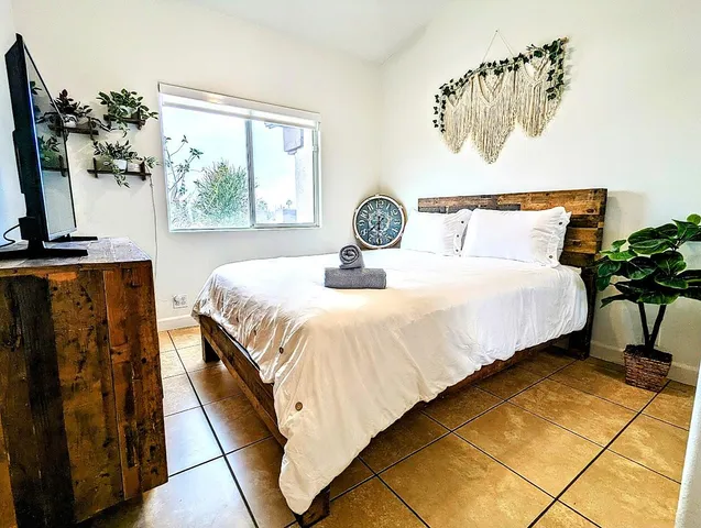 a bedroom with a bed and a window