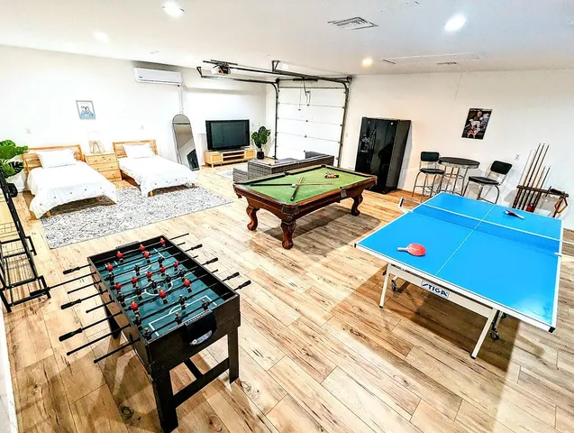 a living room with furniture a rug and a flat screen tv