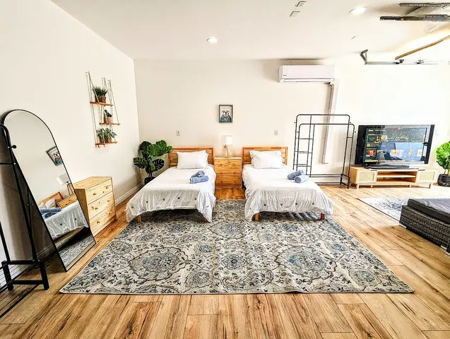 a bedroom with two beds and a couch