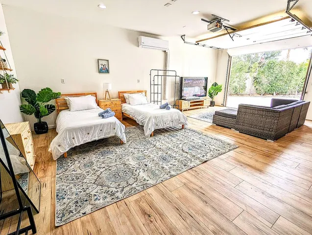 a bedroom with furniture and a large window