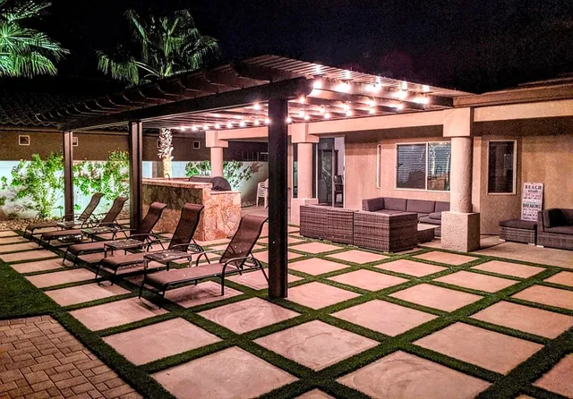 a view of a patio with table and chairs and potted plants