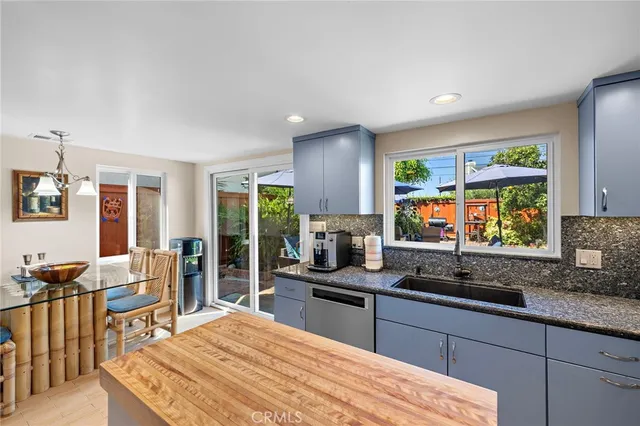 a kitchen with stainless steel appliances microwave stove refrigerator and cabinets