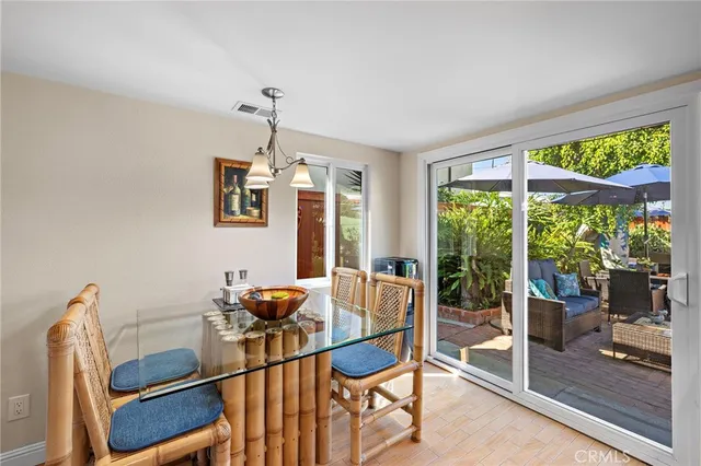 a dining room with furniture and large windows