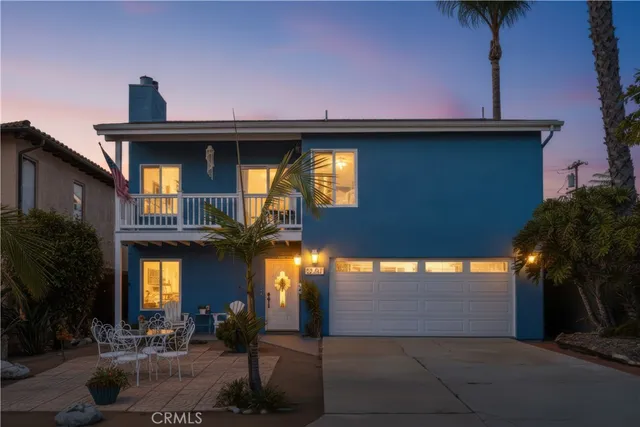a view of a house with a lot of windows and plants