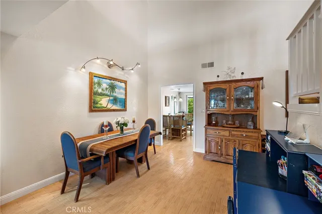 a dining room with furniture and wooden floor