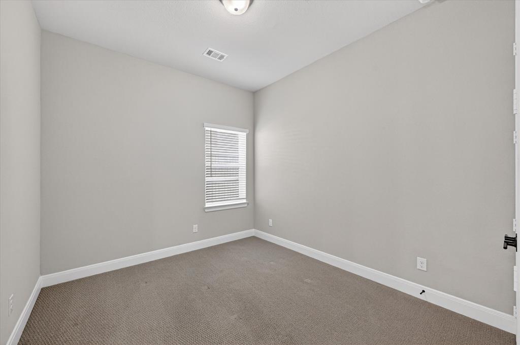 2237 Pika Road Northlake, TX 76247 - Photo 33 of 37 Neutral toned room featuring light gray walls, white baseboards, and textured carpeting