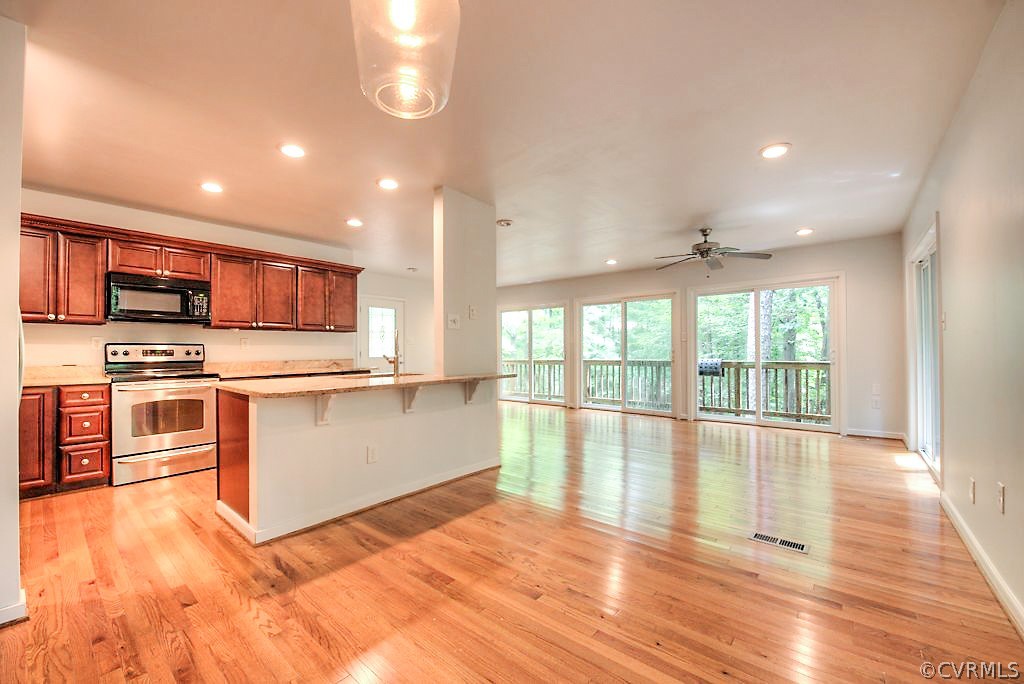 3213 Shadow Oaks Road Midlothian, VA 23112 - Photo 6 of 24 Kitchen, dining and view into the woodland
