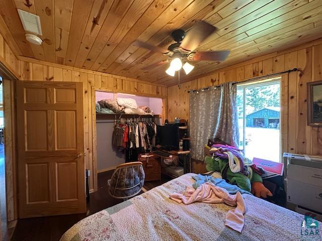 1383 Kelly Trail Isabella, MN 55607 - Photo 15 of 40 Bedroom featuring wood walls, wooden ceiling, a closet, dark wood-style floors, and ceiling fan