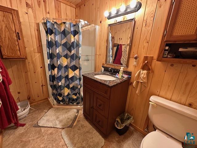 1383 Kelly Trail Isabella, MN 55607 - Photo 19 of 40 Bathroom with wood walls, a shower with shower curtain, and vanity