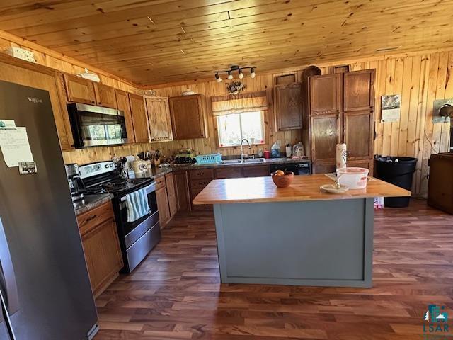 1383 Kelly Trail Isabella, MN 55607 - Photo 3 of 40 Kitchen with appliances with stainless steel finishes, a center island, wood walls, dark wood-style floors, and wood ceiling
