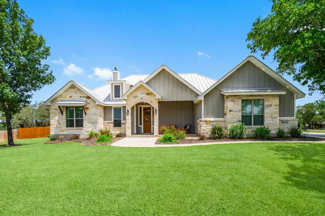 a front view of a house with a yard and porch
