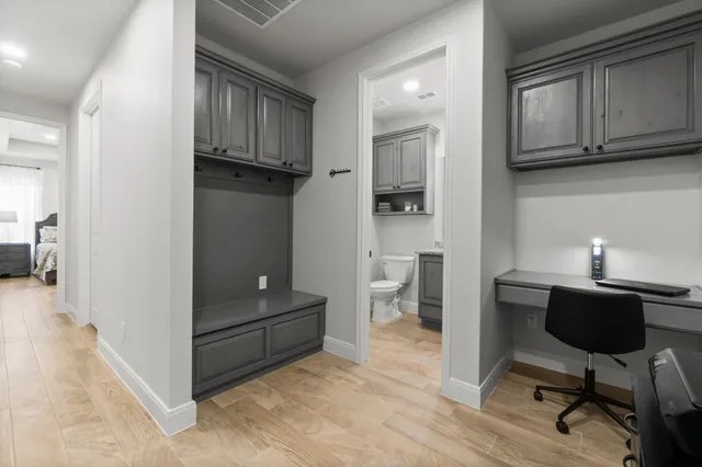 a view of a workspace with furniture and wooden floor