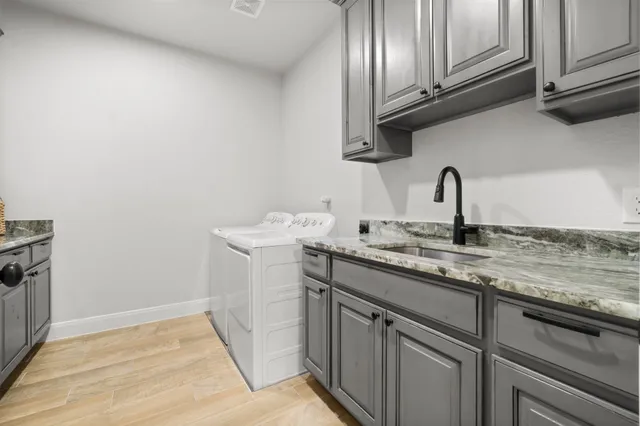 a kitchen with granite countertop stainless steel appliances a sink and cabinets