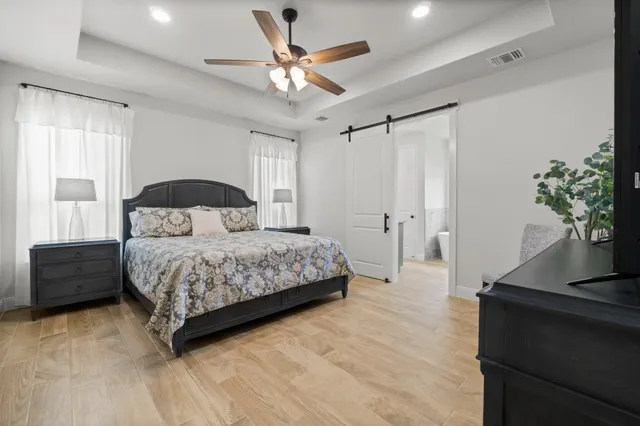 a bedroom with a bed and a potted plant