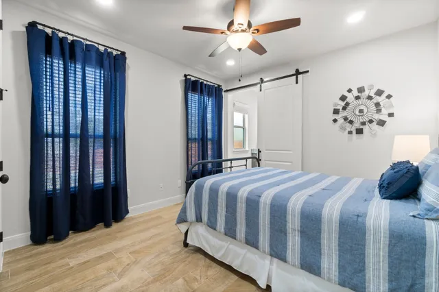 a bedroom with a large bed and a chandelier