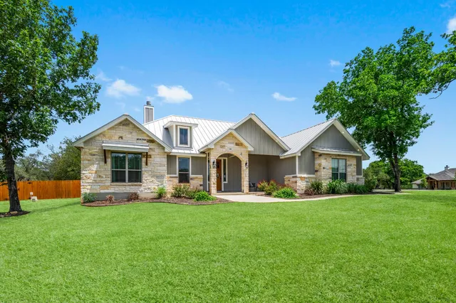 a front view of house with yard and green space