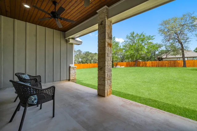 a view of a porch with furniture and yard