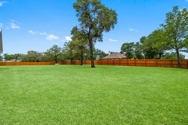 a view of outdoor space with swimming pool and trees in the background