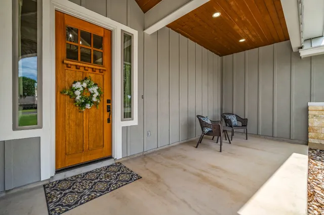 a view of a hallway with wooden floor and a window