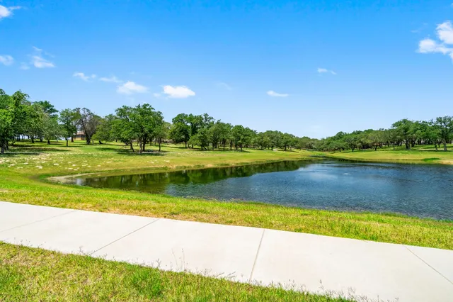 a view of a lake with houses in the background