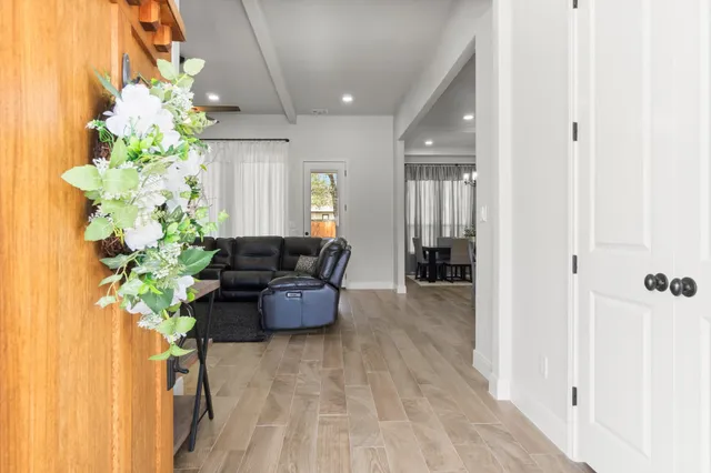 a living room with furniture and flowers