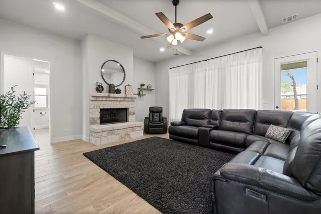 a living room with furniture a fireplace and a potted plant
