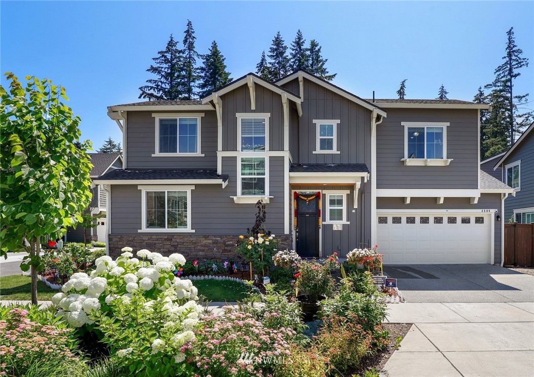 4606 187th Place Southeast Bothell, WA 98012 - Photo 1 of 40 a front view of a house with a yard