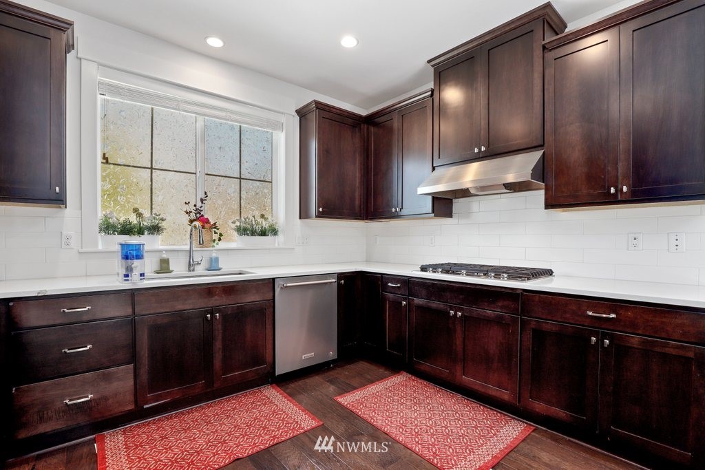 4606 187th Place Southeast Bothell, WA 98012 - Photo 11 of 40 a kitchen with stainless steel appliances granite countertop wooden cabinets a sink and dishwasher