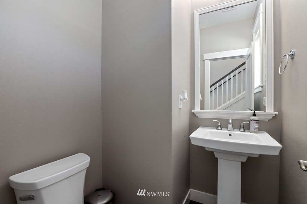 4606 187th Place Southeast Bothell, WA 98012 - Photo 14 of 40 a bathroom with a sink a toilet and mirror