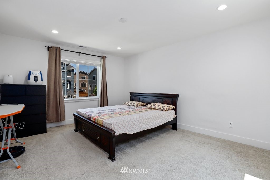 4606 187th Place Southeast Bothell, WA 98012 - Photo 15 of 40 a room with a bed and a table in it