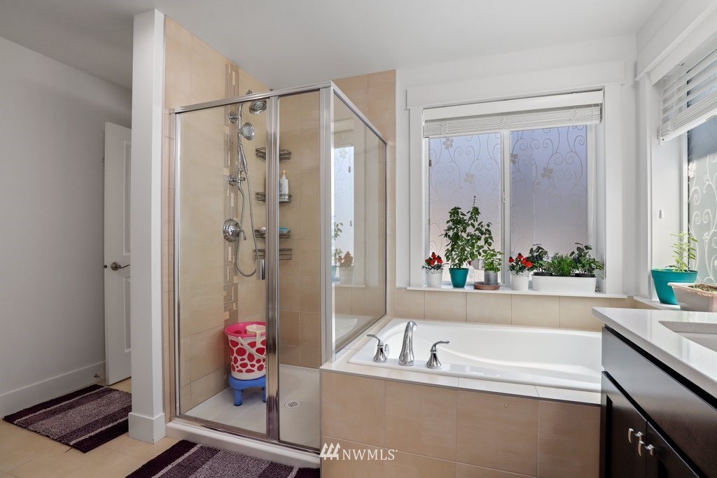 4606 187th Place Southeast Bothell, WA 98012 - Photo 17 of 40 a bath room with a bath tub and a shower