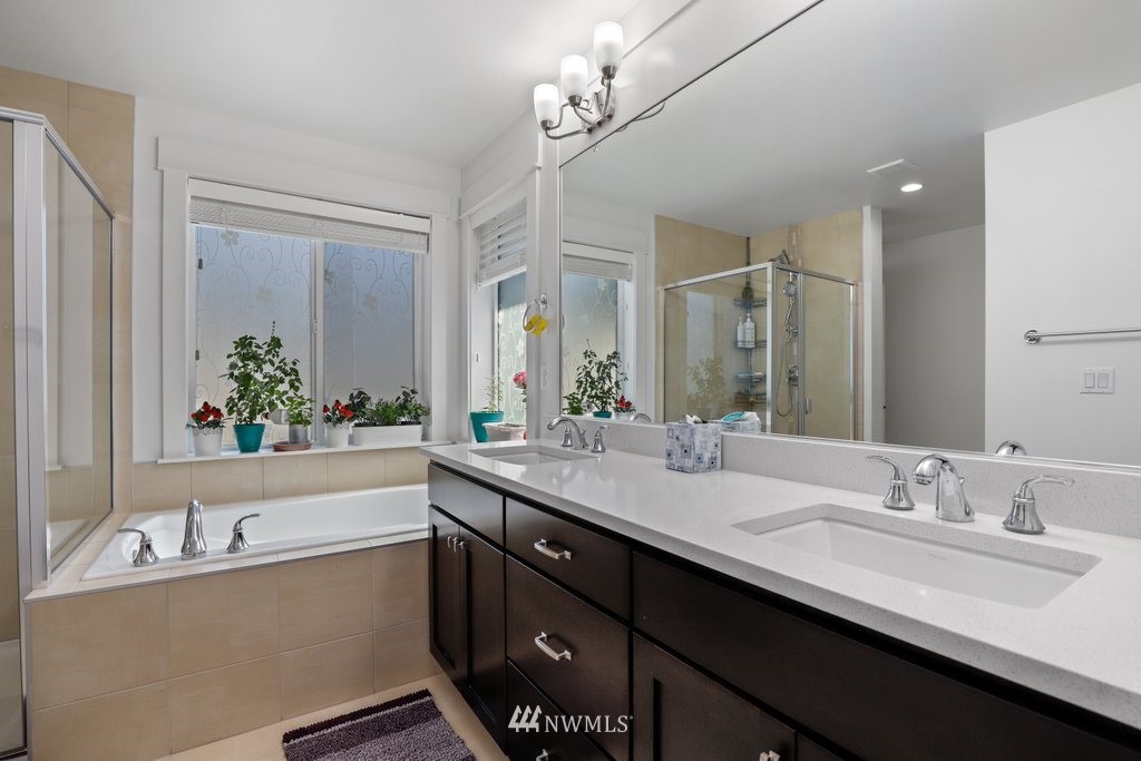 4606 187th Place Southeast Bothell, WA 98012 - Photo 18 of 40 a bathroom with a double vanity sink a mirror and a bathtub
