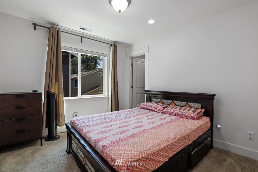 4606 187th Place Southeast Bothell, WA 98012 - Photo 20 of 40 a bed sitting in a bedroom next to a window