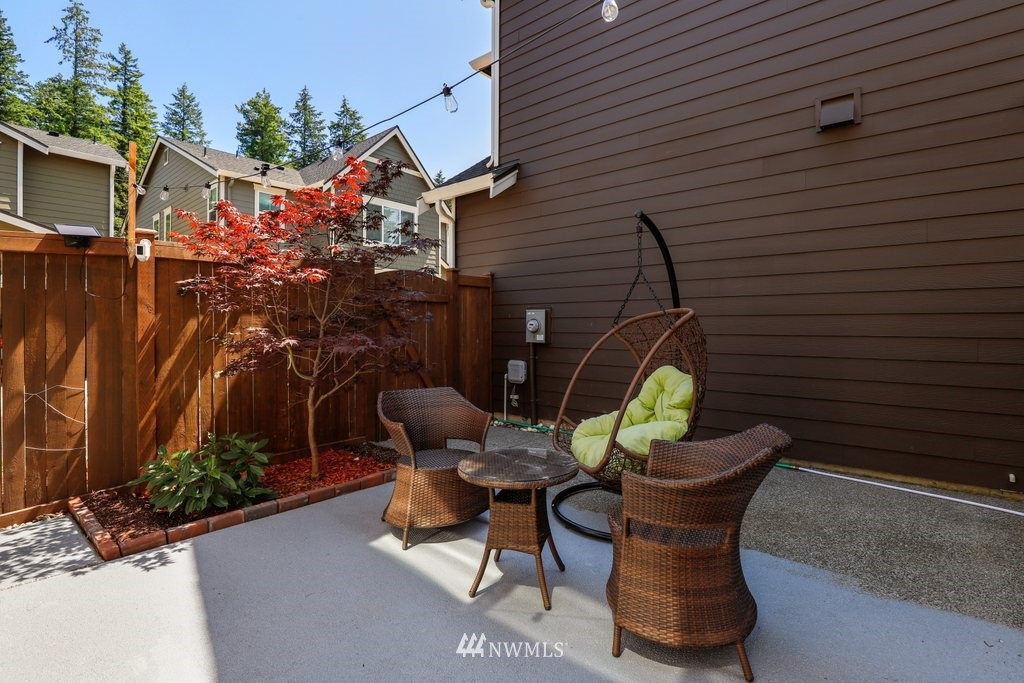 4606 187th Place Southeast Bothell, WA 98012 - Photo 26 of 40 a backyard of a house with table and chairs