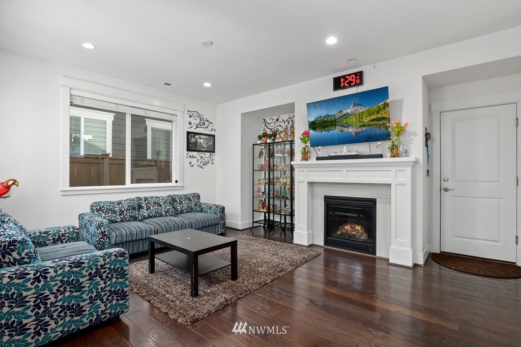 4606 187th Place Southeast Bothell, WA 98012 - Photo 6 of 40 a living room with furniture a flat screen tv and a fireplace