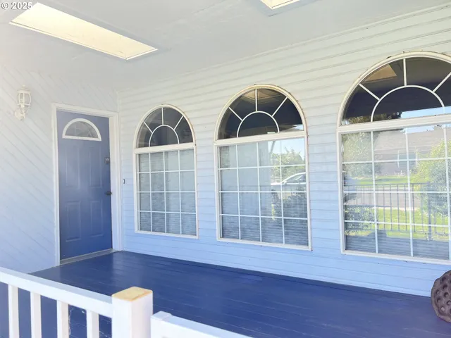 a view of wooden floor and windows in the room