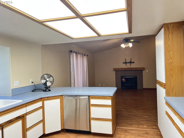 a view of a livingroom with a fireplace and a chandelier
