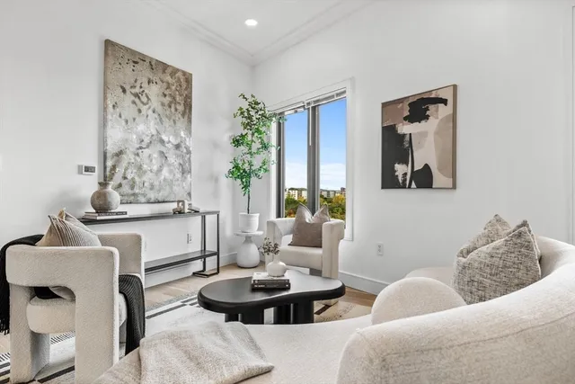 a living room with furniture and a painting