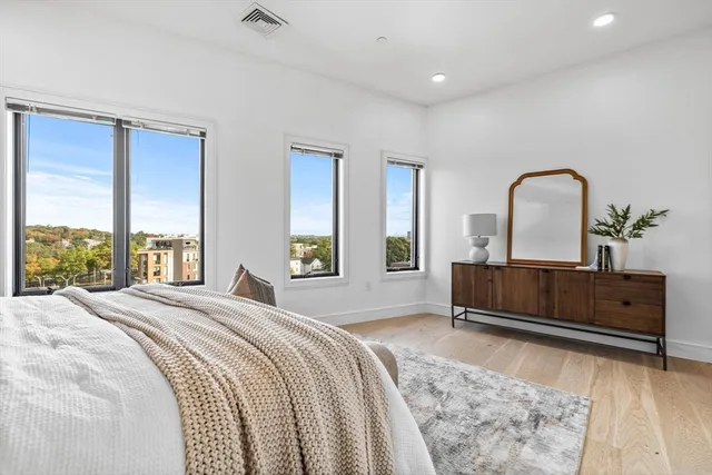 a bedroom with a bed and a large window