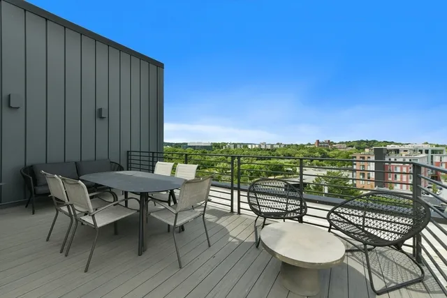 a balcony with table and chairs