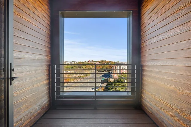 a view of a balcony with floor to ceiling window with stairs