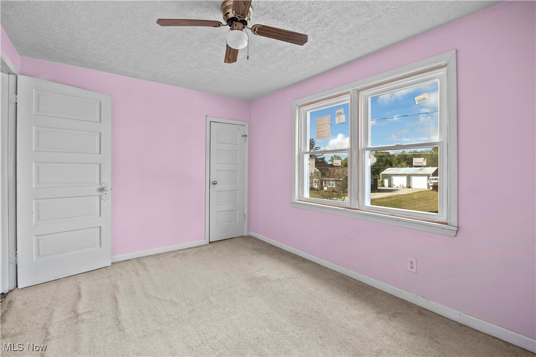 6927 North Wildacre Road Curtice, OH 43412 - Photo 35 of 44 Unfurnished bedroom featuring light colored carpet, a textured ceiling, and ceiling fan