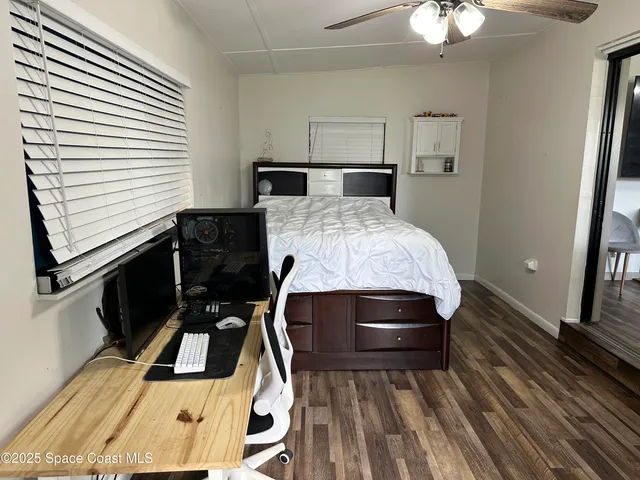 a room with wooden floor and furniture