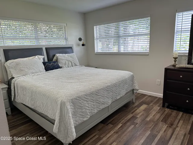 a bedroom with double bed and window