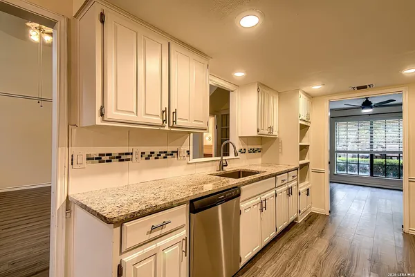 a kitchen with a sink stove and cabinets