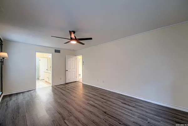 a bathroom with a granite countertop sink a mirror and shower
