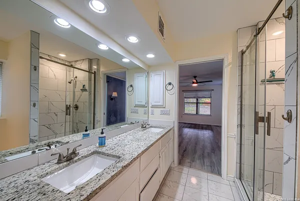 a bathroom with a granite countertop sink and a mirror
