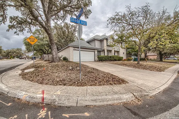 a view of a white house with a snow on the road