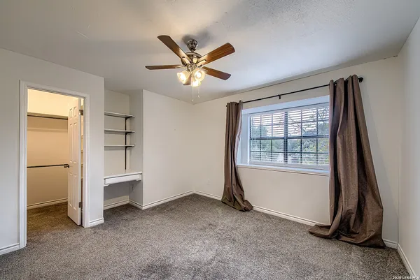 a view of a livingroom with a ceiling fan and hardwood floor