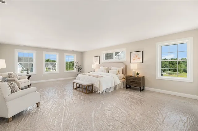 a spacious bedroom with a bed and a couch